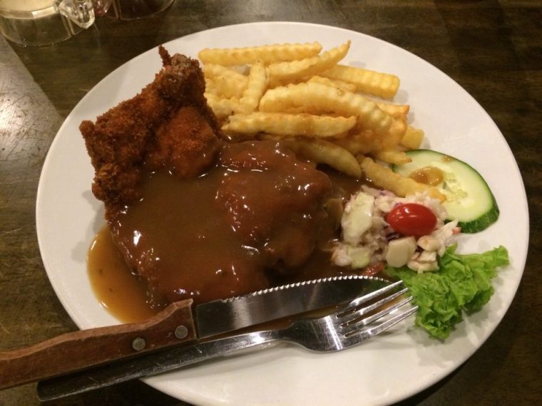 Pinggan chicken chop dengan sos lada hitam, kentang goreng dan coleslaw dari kedai makan di KL.